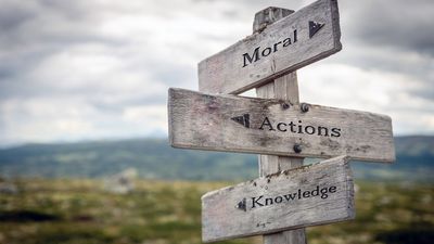 Moral, actions and knowledge text on wooden sign post outdoors in landscape scenery. Business, quotes and motivational theme concept.