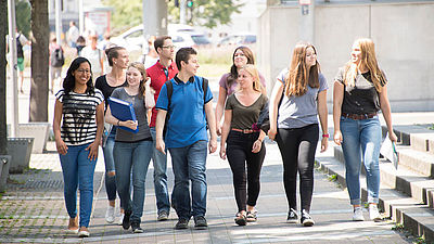 Studierendengruppe läuft auf dem Campus