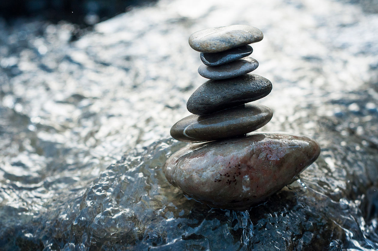 Closeup of stone balance on rocks in the river